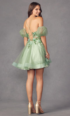A woman models the Puff-Sleeve Short Butterfly Homecoming Dress 901, featuring light green fabric, puffy sleeves, butterfly appliqué, sheer waist, and an open lace-up back—perfect for making a statement against the gray background.