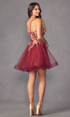 A woman in the Short A-Line Butterfly Homecoming Dress 902, a red sleeveless party dress with butterfly accents and crisscross back straps, stands smiling and facing slightly away from the camera.