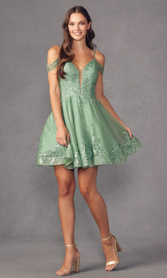 A woman wearing the Glitter-Print Short Babydoll Homecoming Dress 903, a light green sequin-embellished outfit, smiles and holds the hem of her dress while standing against a plain gray background.
