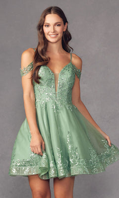 A woman smiles and holds the edge of her dress while wearing the Glitter-Print Short Babydoll Homecoming Dress 903, a short light green homecoming style with sequin embellishments, standing against a gray background.