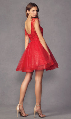 A woman stands in profile against a plain gray backdrop, wearing the Short Babydoll Homecoming Dress with Feathers 881 and beige high-heeled sandals.