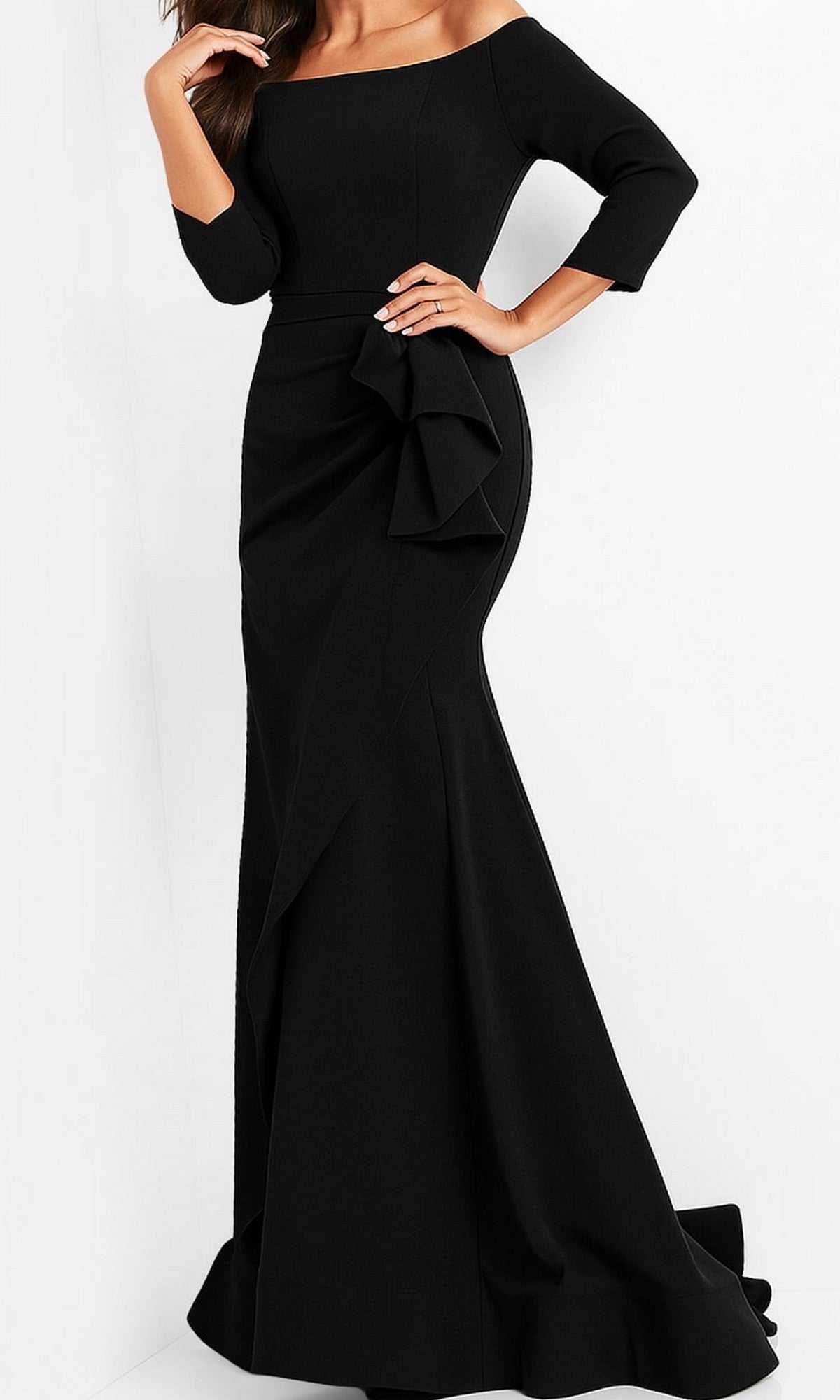 A woman wearing the Jovani Mother-of-the-Bride Long Formal Dress 00446 in black—a long, fitted off-the-shoulder evening gown with three-quarter sleeves and a dramatic ruffle detail at the waist—makes an elegant choice for a formal event or as a mother-of-the-bride dress.