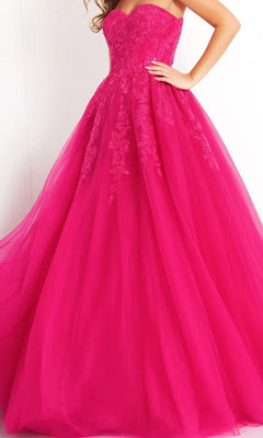 Woman wearing the Long Prom Dress: Jovani 00915—a hot pink strapless tulle ballgown with a fitted bodice and full skirt, adorned with exquisite floral lace details.