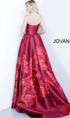 A woman stands with her back to the camera in the Jovani Strapless Floral Long Prom Ball Gown 02038, showing off its elegant A-line silhouette against a white background. The word "JOVANI" appears on the right side.