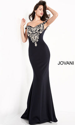 A woman models the Jovani Embroidered Off-Shoulder Prom Dress 02576, a fitted, floor-length gown with silver embroidery on the bodice, posing in front of a white backdrop featuring the "JOVANI" logo.