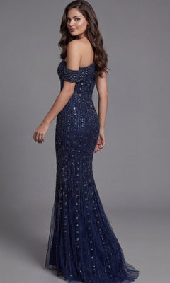 A woman wearing the Jovani Asymmetrical Beaded Long Formal Dress 03124 in navy blue stands on a gray background, facing slightly away from the camera.
