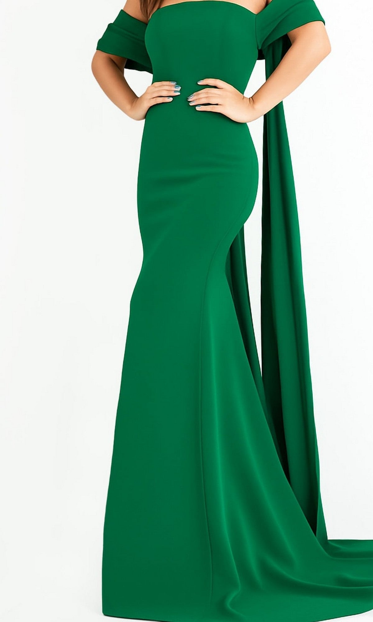 A person poses in the Long Prom Dress by Jovani 04350—a fitted emerald evening gown crafted from crepe, featuring a strapless design with draped off-the-shoulder sleeves and a floor-length hem—set against a plain white background.
