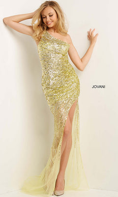 A woman poses in the Long One-Shoulder Prom Dress 05647 by Jovani, featuring sequins, a high slit, and sheer tulle. The fitted mesh design shimmers elegantly for a chic evening look against a white wall with "JOVANI" displayed.