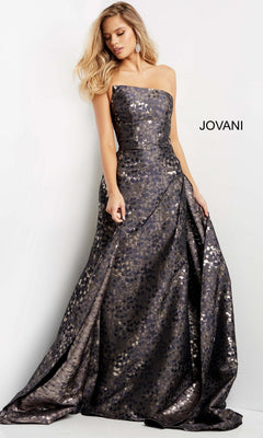 A woman is wearing the Long Formal Dress: Jovani 06255, a strapless jacquard gown featuring a metallic, patterned finish and a full skirt, as she poses against a plain white background.