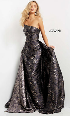 A woman poses against a white background wearing the Jovani 06255 long formal dress in grey/brown, showcasing the sophistication of this strapless, metallic jacquard gown by designer Jovani, with the brand name visible.