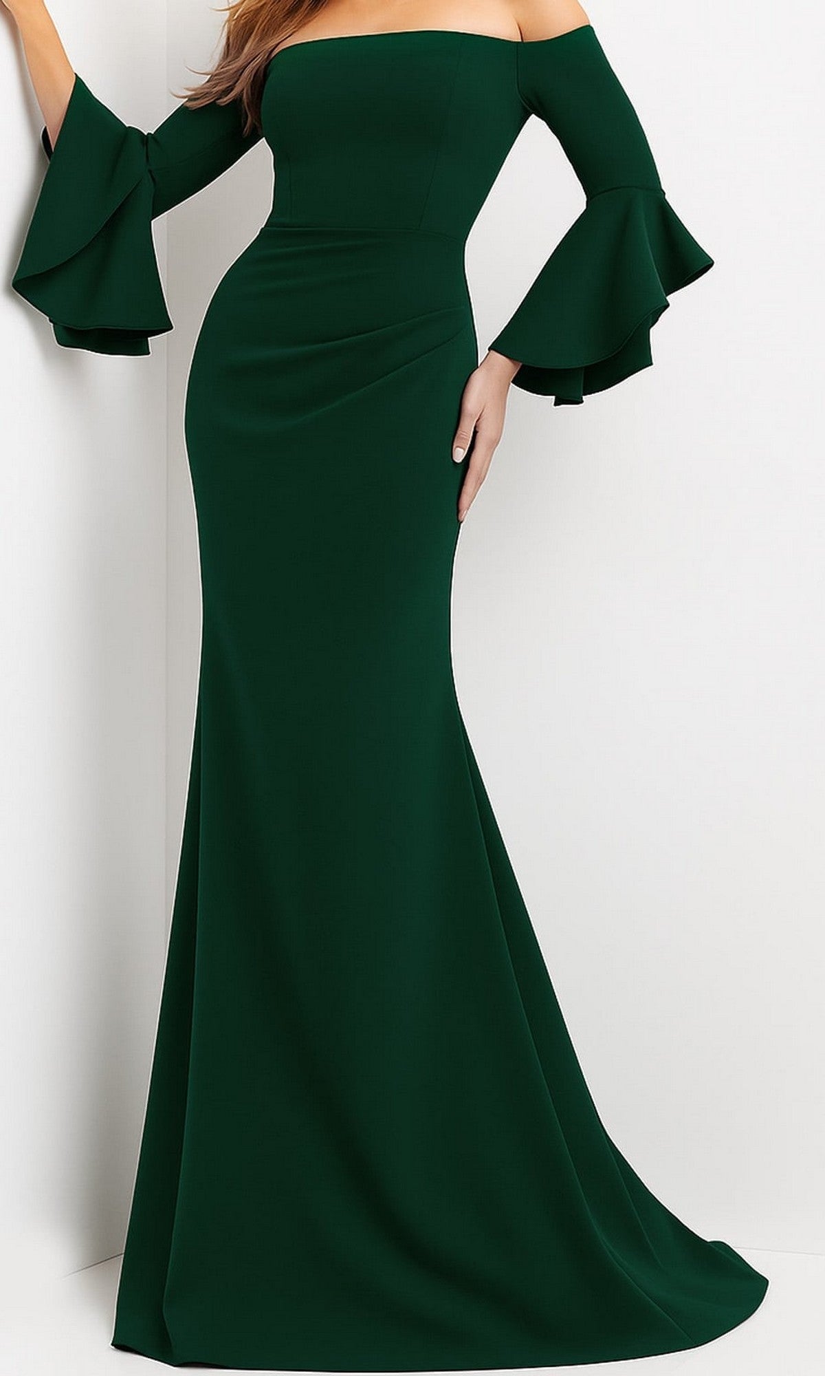 A woman wearing the Bell-Sleeve Designer Evening Gown: Jovani 07065 in hunter, a floor-length, off-the-shoulder gown with flared sleeves, stands against a white background.