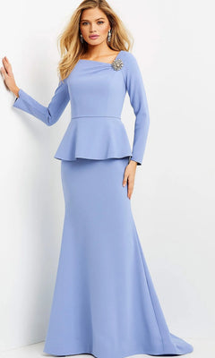A woman wearing the Long Formal Dress: Jovani 07131 in light-blue, a long peplum gown with long sleeves, adorned with a brooch on the shoulder and statement earrings, stands against a plain white background.