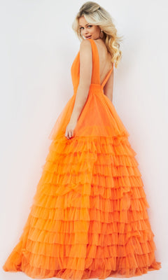 A woman poses against a white background in the Jovani V-Neck Long Ruffled Prom Ball Gown 07264, a bright orange, sleeveless, backless dress with layered tulle ruffles, glancing over her shoulder.