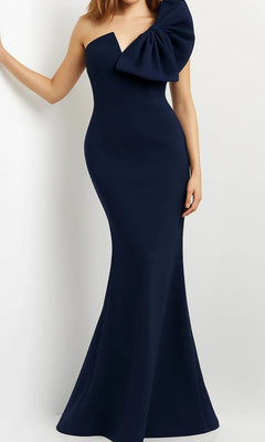 A woman wearing the Jovani 07306 long formal dress in navy, a fitted floor-length gown featuring an elegant mermaid silhouette with one shoulder strap and a dramatic ruffle accent on the left shoulder.