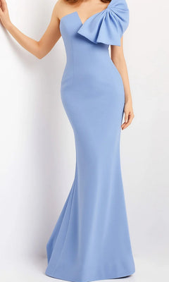 A person wears the Long Formal Dress: Jovani 07306 in light-blue—a fitted, floor-length, one-shoulder designer gown featuring a dramatic ruffle accent on the shoulder—standing against a plain background.