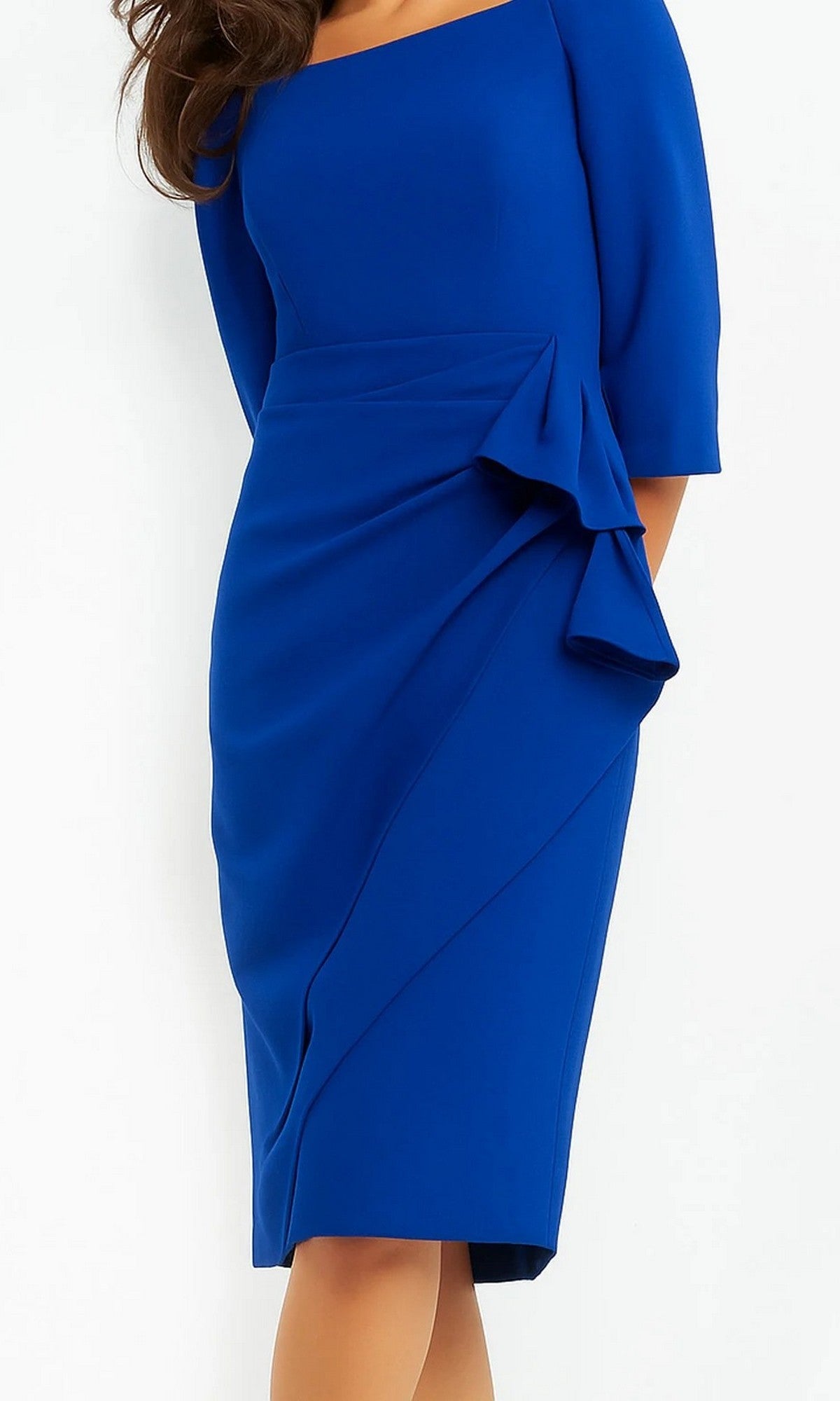A woman wearing the Jovani 07442 short wedding guest dress in royal, featuring a fitted, knee-length silhouette with elbow-length sleeves and a decorative side ruffle detail, stands against a plain white background.