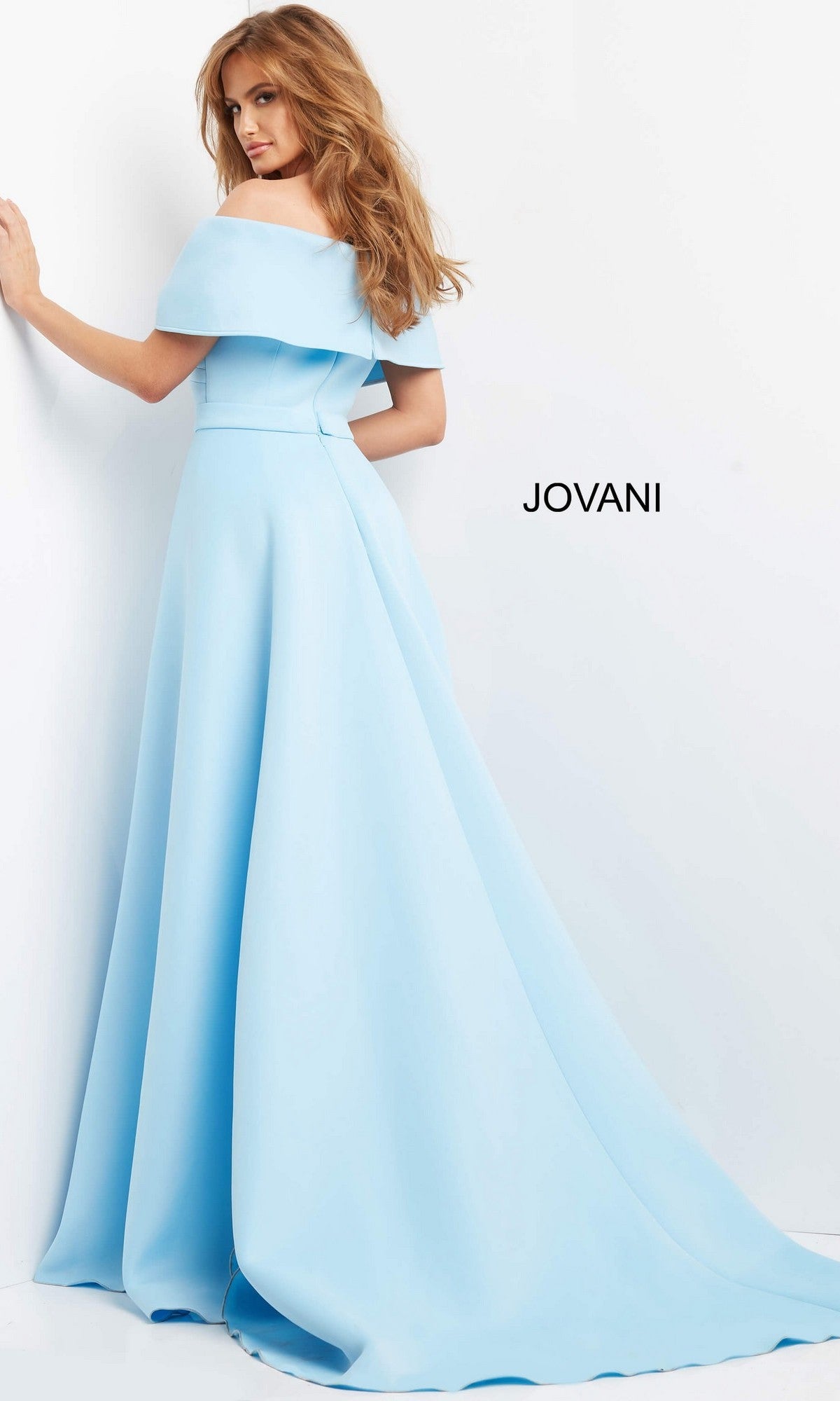 A woman wearing the Jovani 07443 Long Formal Dress—a light blue, off-shoulder, floor-length gown featuring a mermaid skirt and a long train—stands against a white background.