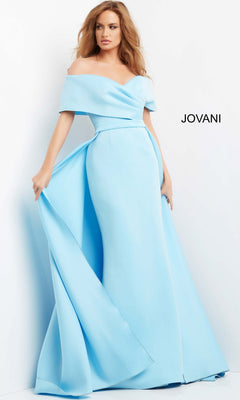 A woman models the Jovani 07443 Long Formal Dress, featuring a light blue off-the-shoulder design with a fitted waist and an elegant mermaid skirt, standing against a white background with “JOVANI” displayed.