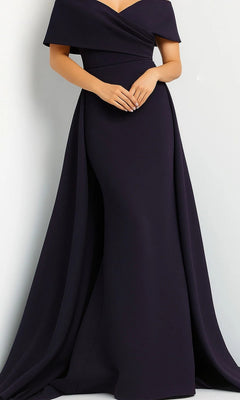 A person wearing the Jovani 07443 Long Formal Dress in navy, featuring an off-the-shoulder neckline, draped fabric, and a subtle mermaid skirt, stands against a plain light background.