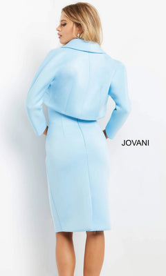 A woman is shown from the back, wearing the Jovani 07556 short wedding guest dress—a light blue, tailored, knee-length design with long sleeves and a collar—standing against a plain white background with “JOVANI” displayed on the right.