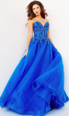 A woman poses in the royal blue Jovani Strapless Sweetheart Long Prom Gown 07946, featuring a beaded bodice and full tulle skirt, against a plain white background.