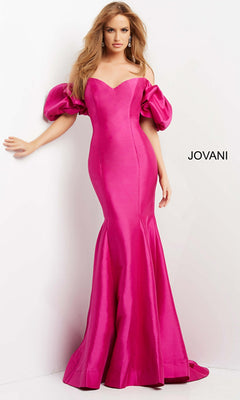 A woman poses in the Jovani Puff-Sleeve Long Mermaid Prom Dress 09031 in orchid, featuring a fitted, off-the-shoulder design with puffed sleeves, set against a white background displaying "JOVANI" text.