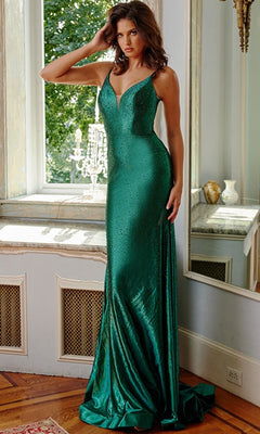 A woman stands indoors by a window, wearing the Jovani Cut-Out-Back Long Beaded Prom Dress 08157 in emerald—a sleeveless, floor-length gown with a shimmering fitted design.