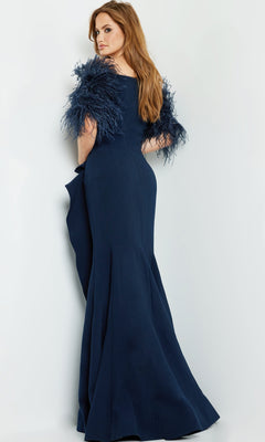 A woman faces away from the camera in a Jovani Feather-Trim Long Formal Dress 09154, a navy blue evening gown with feather sleeves, set against a plain light background.