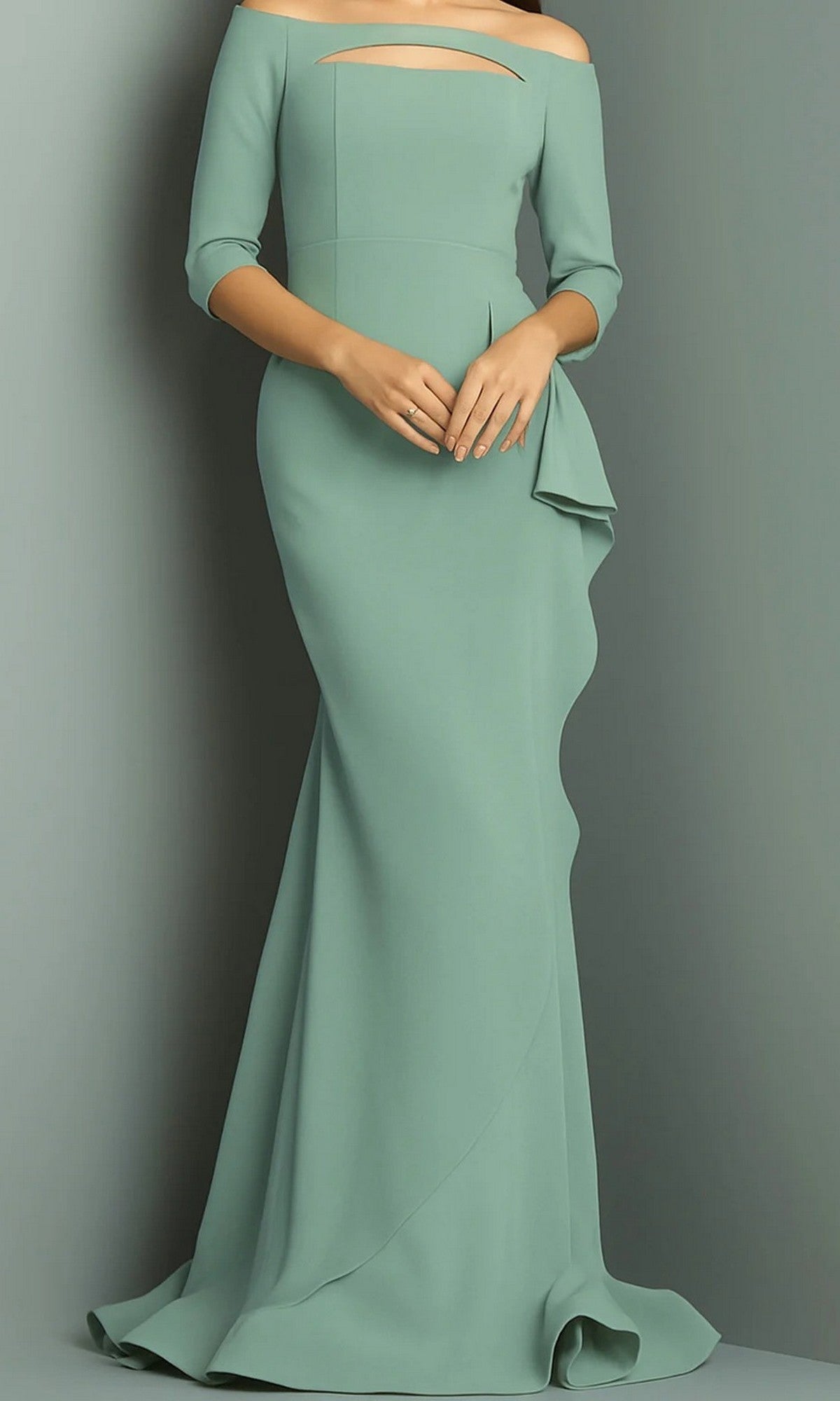 A woman wearing the Jovani 09623 long formal dress in mint—a floor-length, off-shoulder evening gown featuring a cutout neckline and ruffled detail on one side—stands against a plain background.