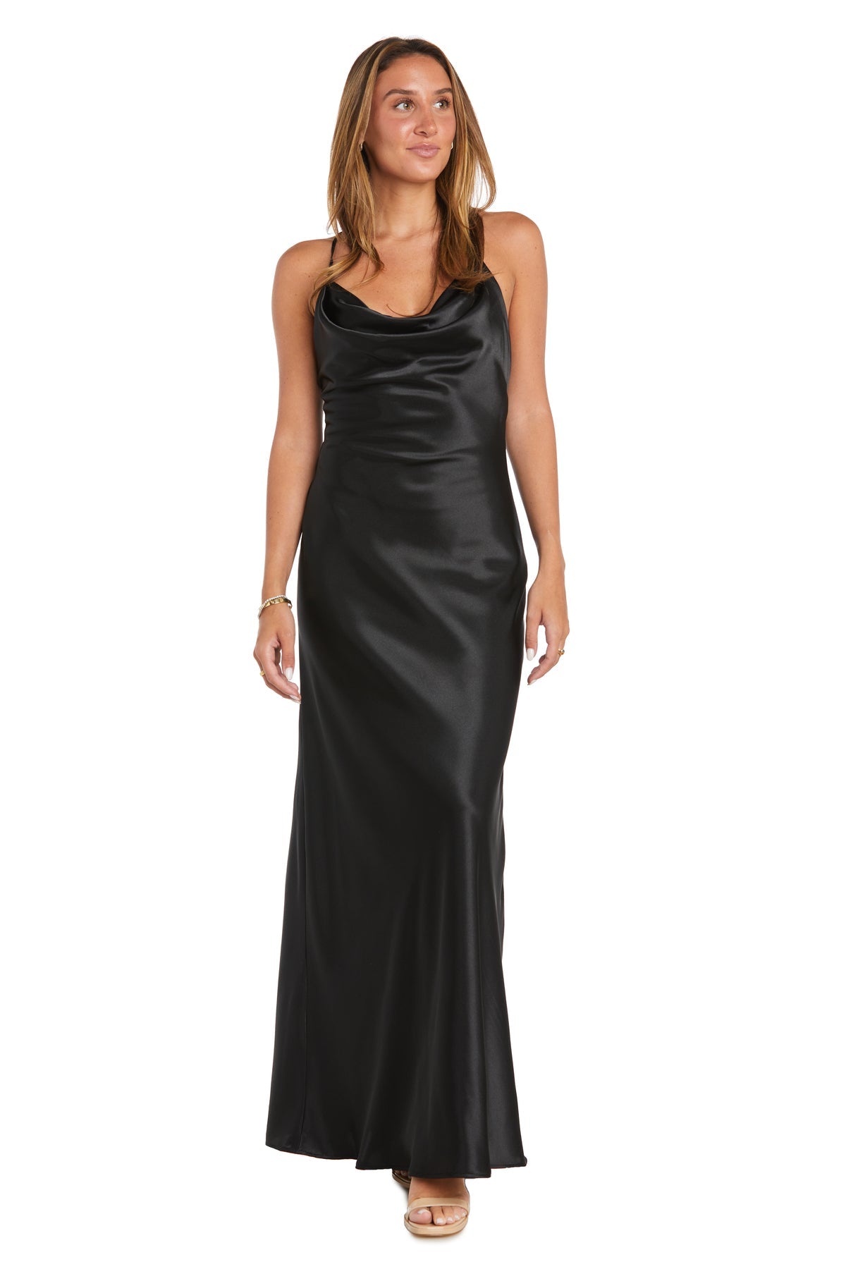 A woman in the Cowl-Neck Long Satin Prom Dress: Morgan 10037N with spaghetti straps and nude heels stands against a white background.