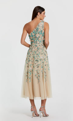 A woman stands gracefully in the Mac Duggal 10086 midi wedding guest dress.