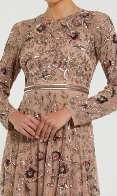 Wearing the Mac Duggal 10093, a beige long sleeve beaded formal dress with intricate floral embroidery, shown from shoulders to knees.