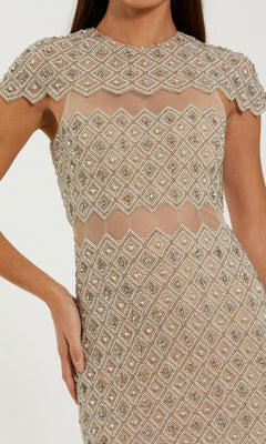 A person wearing the Long Formal Dress: Mac Duggal 10147, a short-sleeved nude midi dress adorned with intricate geometric beadwork and pearl embellishments in a striking diamond pattern.