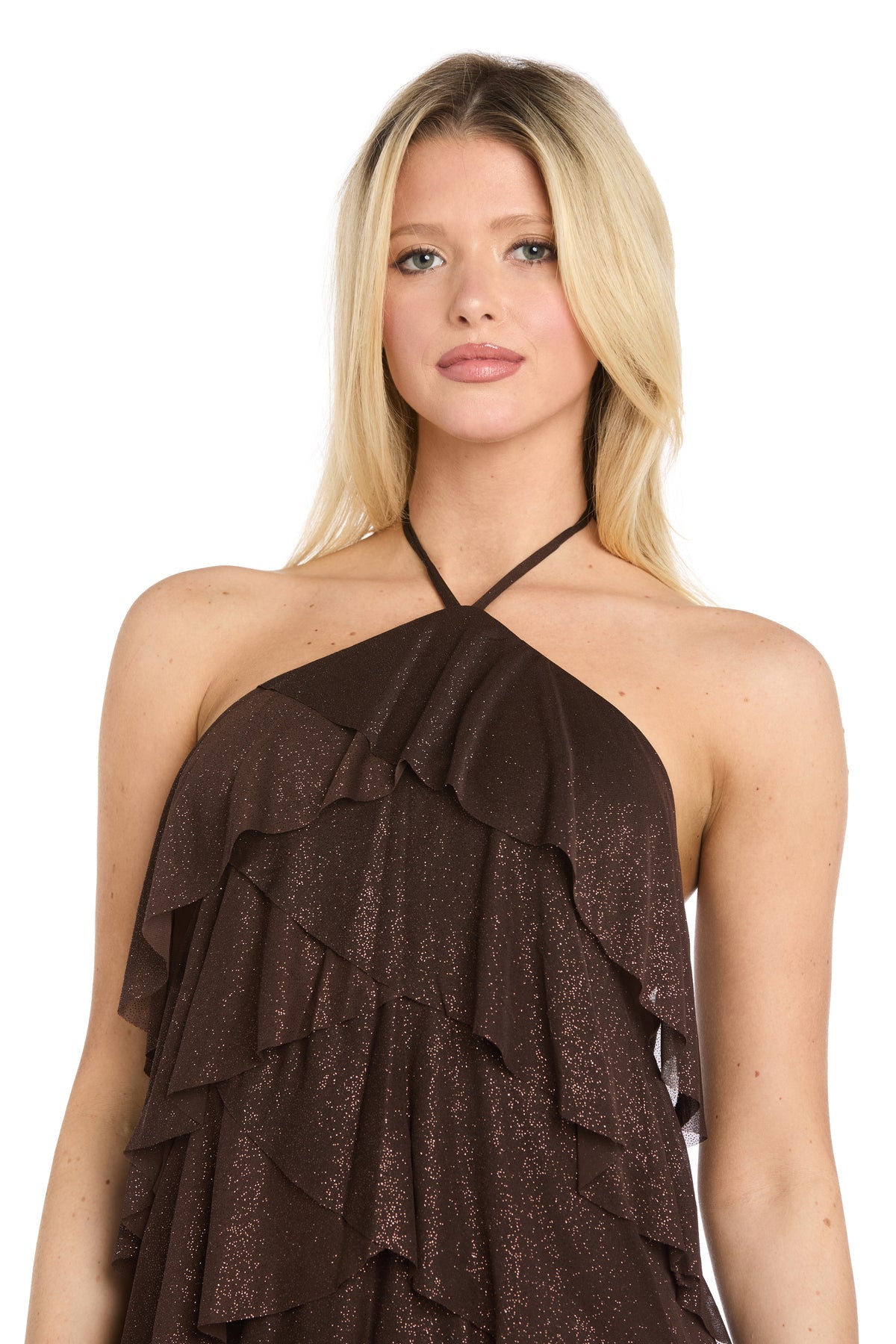 A person with long blonde hair wears the Morgan 10196 short homecoming dress, which features a brown halter neckline and ruffled tiers, while standing against a plain white background.