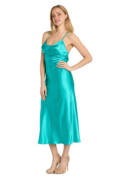A woman stands wearing the Satin Semi-Formal Midi Dress: Morgan 10248—sleeveless, teal, with a cowl neckline and spaghetti straps—paired with beige high-heeled sandals against a white background.