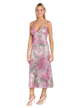 A woman in the Morgan 10253 Semi-Formal Floral Sequin Dress, tea-length and sleeveless with thin straps in pink and silver, paired with strappy high-heeled sandals, stands against a white background.