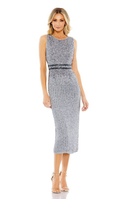 A woman poses in strappy heels against a white background, wearing the Mac Duggal 10509 short sequin wedding guest dress featuring a sleeveless design and fitted waist.