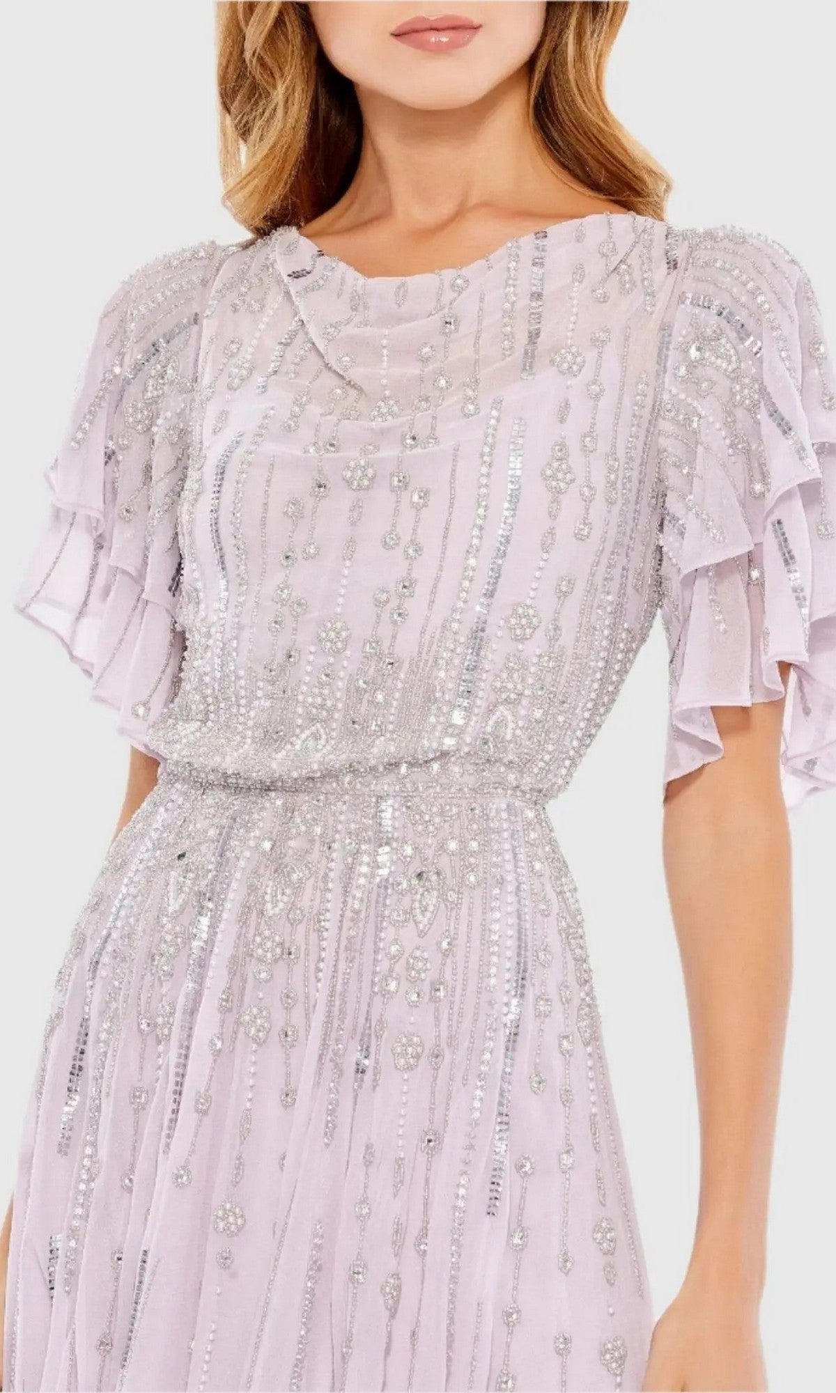 A woman wearing the Mac Duggal 10690 midi wedding guest dress, featuring lilac sequins, short ruffled sleeves, and intricate silver embellishments.