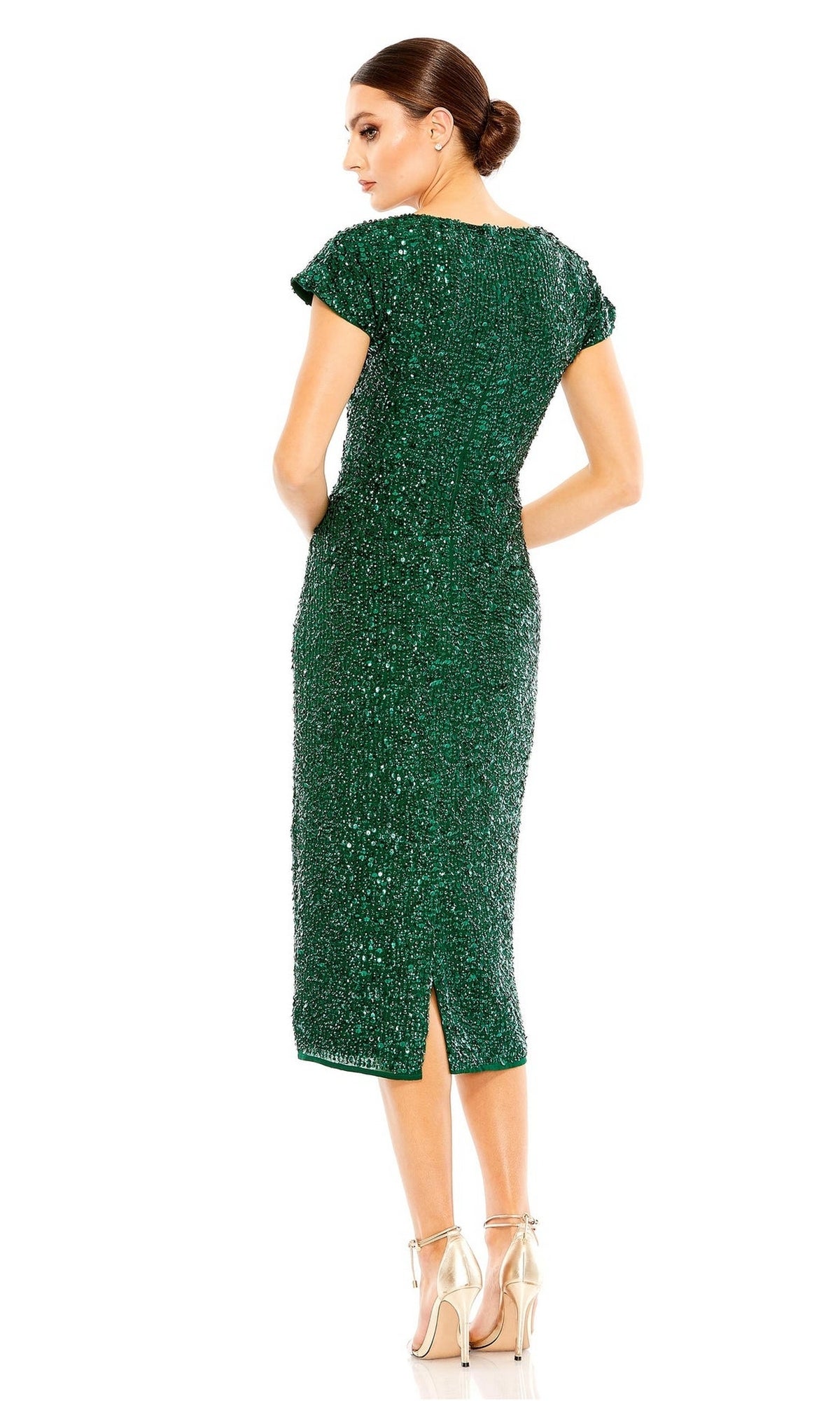 Woman in profile wearing the Mac Duggal 10766 fitted green midi sequin wedding guest dress with cap sleeves and a back slit, looking over her shoulder.