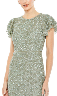 A woman wearing the Short Wedding Guest Dress 10771 by Mac Duggal—a fitted light green midi dress with ruffled short sleeves and all-over beaded embellishments, perfect for chic semi-formal occasions.