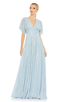 A woman models the Mac Duggal 10807, a short sleeve blue formal dress with sequins and a V-neckline, standing against a white background.