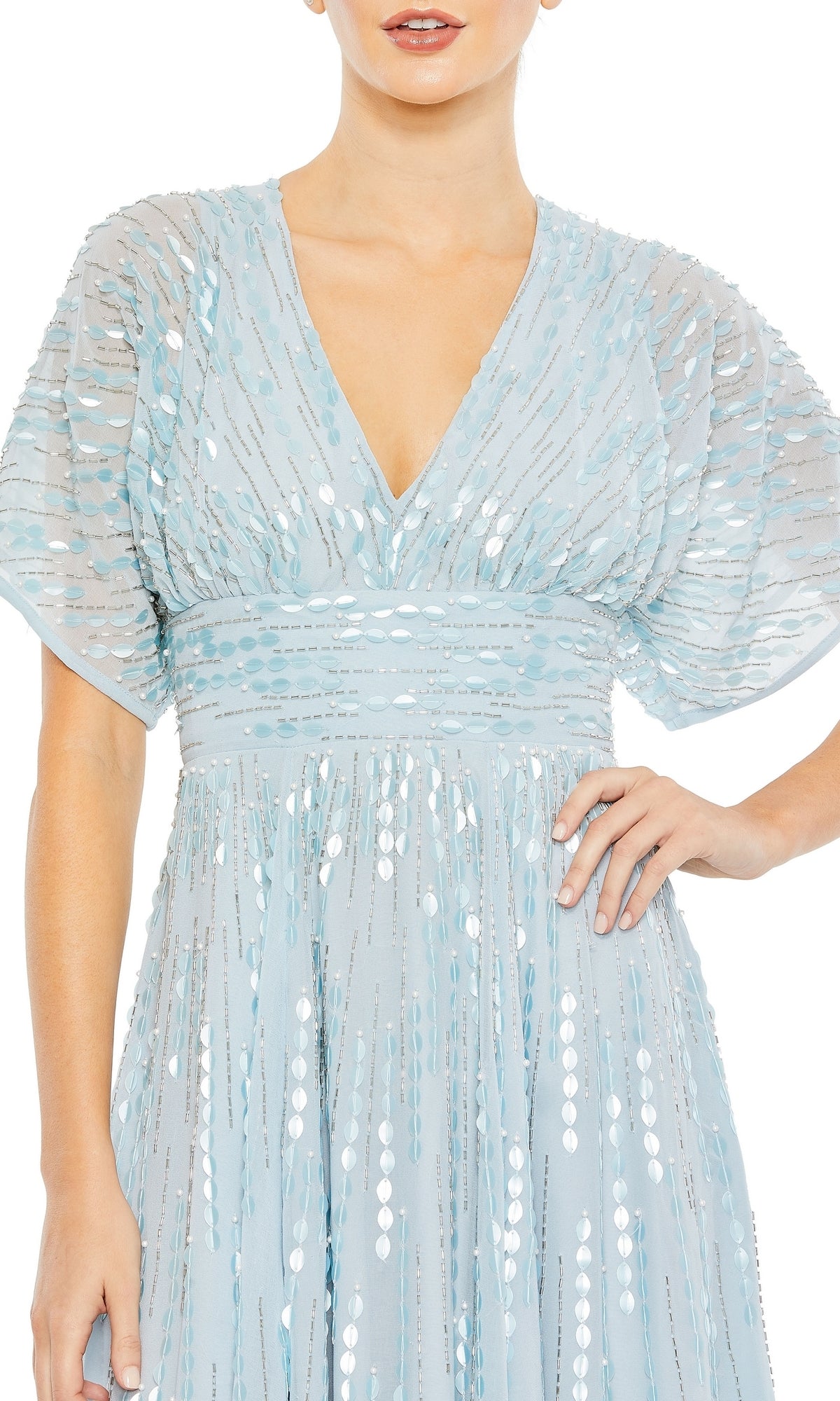 A woman wears the Mac Duggal 10807: a powder blue formal dress with silver stripes, deep V-neckline, short sleeves, and fitted waist for an elegant evening look.