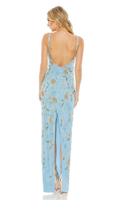 A woman stands facing away, wearing the Long Formal Dress 10808 by Mac Duggal—a light blue, sleeveless dress with a floral pattern, open low back, and back slit.
