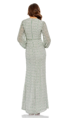 Woman stands with her back to the camera, wearing the Mac Duggal 10871 long formal dress in light green, featuring long sleeves, vertical stripes, and subtle embellishments.