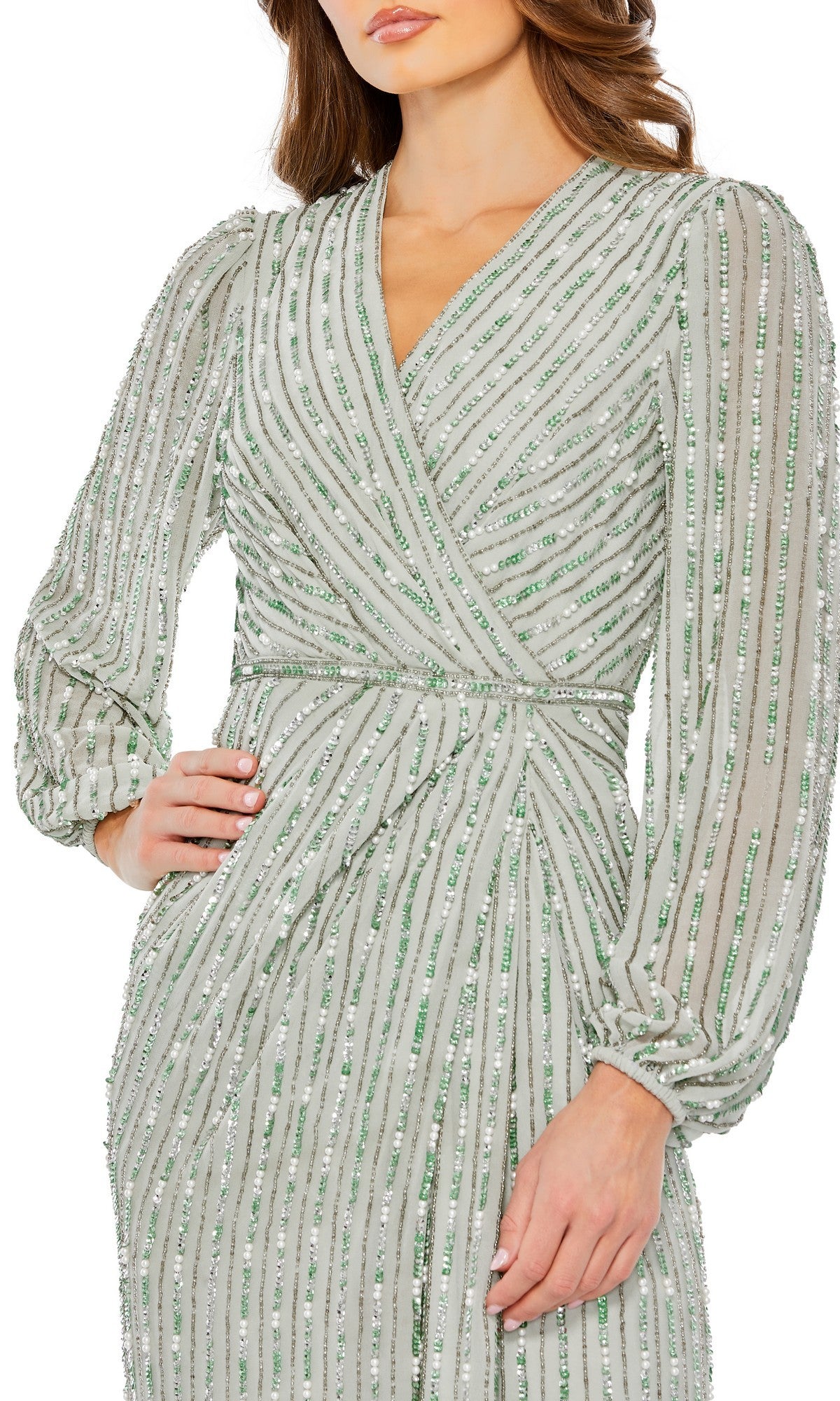 Woman wearing a long-sleeved, light green Mac Duggal 10871 formal dress with sequin vertical and diagonal stripes; hand on hip, cropped at the knees.