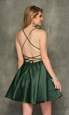 A woman models the Backless Dark Green Short Homecoming Dress 10888, featuring crisscross straps, as she stands with her back to the camera against a textured grey background.