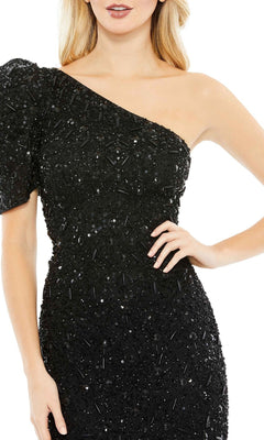 A woman poses confidently with one hand on her hip in the Long Formal Dress 10912 by Mac Duggal—a black, fitted, beaded, one-shoulder gown featuring a short sleeve.