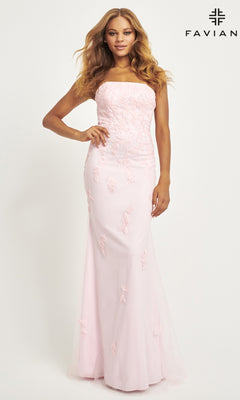Woman wearing the Faviana Strapless Long Beaded Prom Dress 11004, a floor-length pale pink gown with floral appliqué, is pictured against a plain white background. "FAVIAN" is displayed in the top right corner.