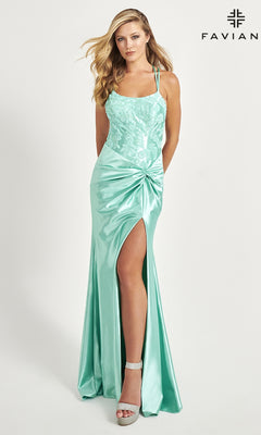 A woman models the Side-Knot Faviana Long Satin Prom Dress 11005 in light green, featuring a lace bodice and thigh-high slit, paired with strappy heels, against a white background with the "FAVIAN" logo in the corner.