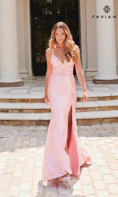 A woman in a light pink Lace-Applique Faviana V-Neck Long Prom Dress 11010 with a thigh-high slit stands outdoors on stone steps before large columns.